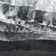 aerial-view-of-atlantic-ocean-waves-washing-black-sandy-beach-picture-id1162370872