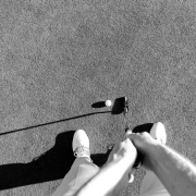 golf-player-at-the-putting-green-hitting-ball-into-a-hole-picture-id672478974