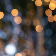Abstract orange and white lights bokeh background at christmas tree.